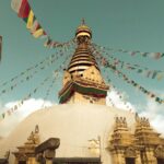 Majestic view of Swayambhunath Stupa with prayer flags in Kathmandu, Nepal.